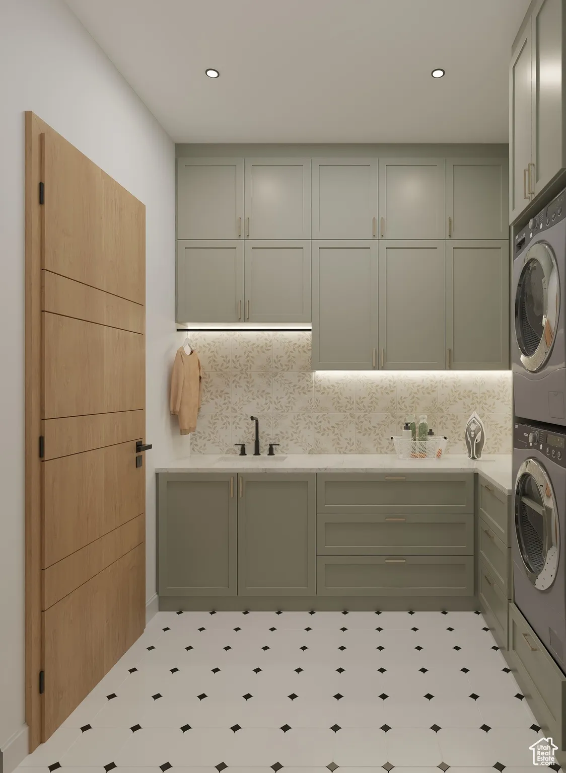 Laundry area with cabinet space, stacked washer and clothes dryer, and recessed lighting