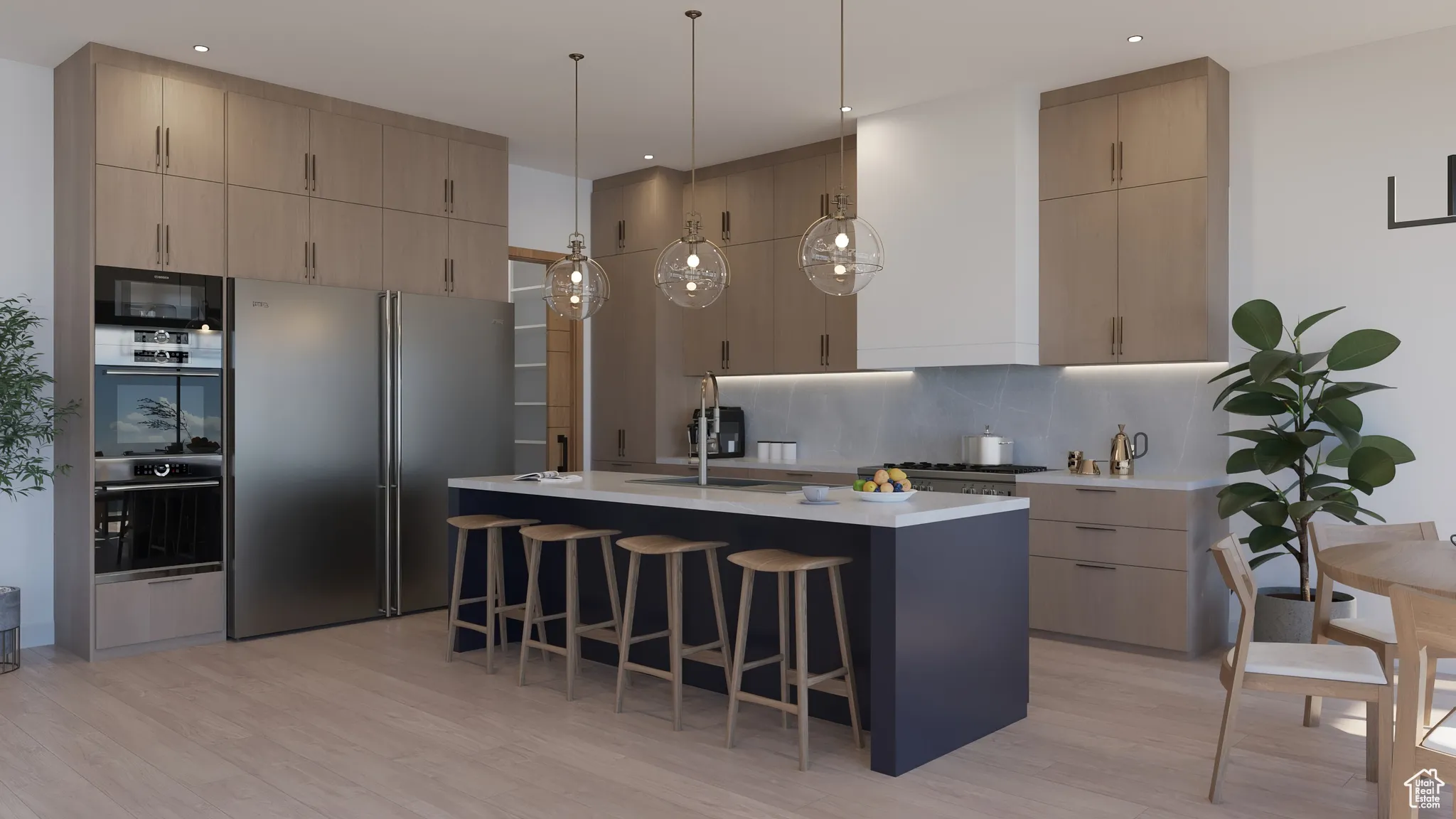Kitchen with stainless steel appliances, light countertops, backsplash, and light wood finished floors