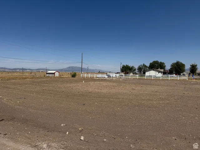 View of yard with a mountain view, a view of rural / pastoral area, and an enclosed horse arena