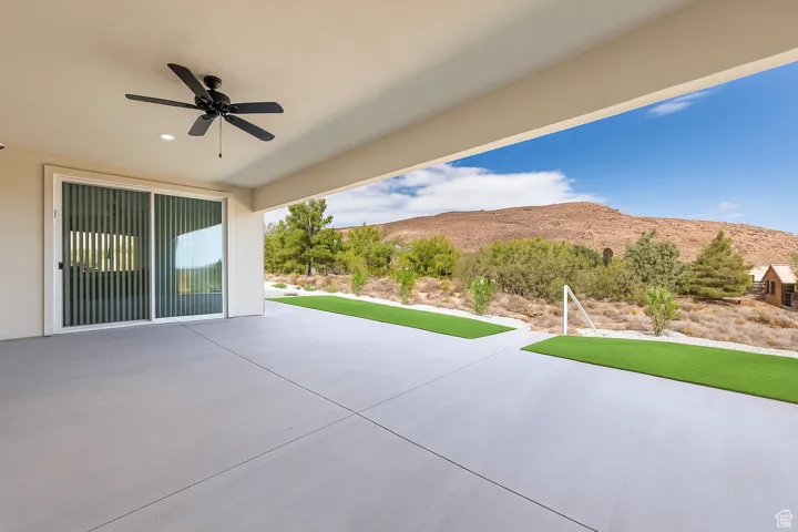 View of rear covered patio / terrace featuring a ceiling fan and a mountain views