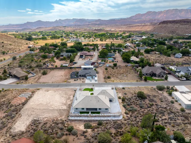Aerial perspective of suburban area with mountains and a desert landscape