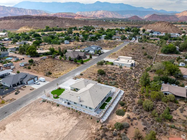 Aerial perspective of suburban area featuring mountains and a desert landscape