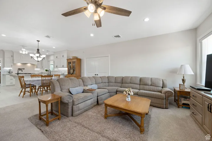 Main Family room area with a ceiling fan, recessed lighting, and light carpet