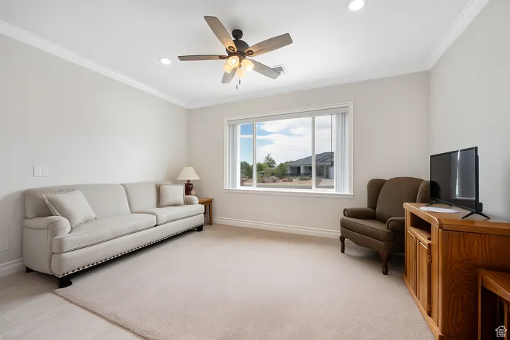 ADU Living area featuring crown molding, a ceiling fan, recessed lighting, and light carpet