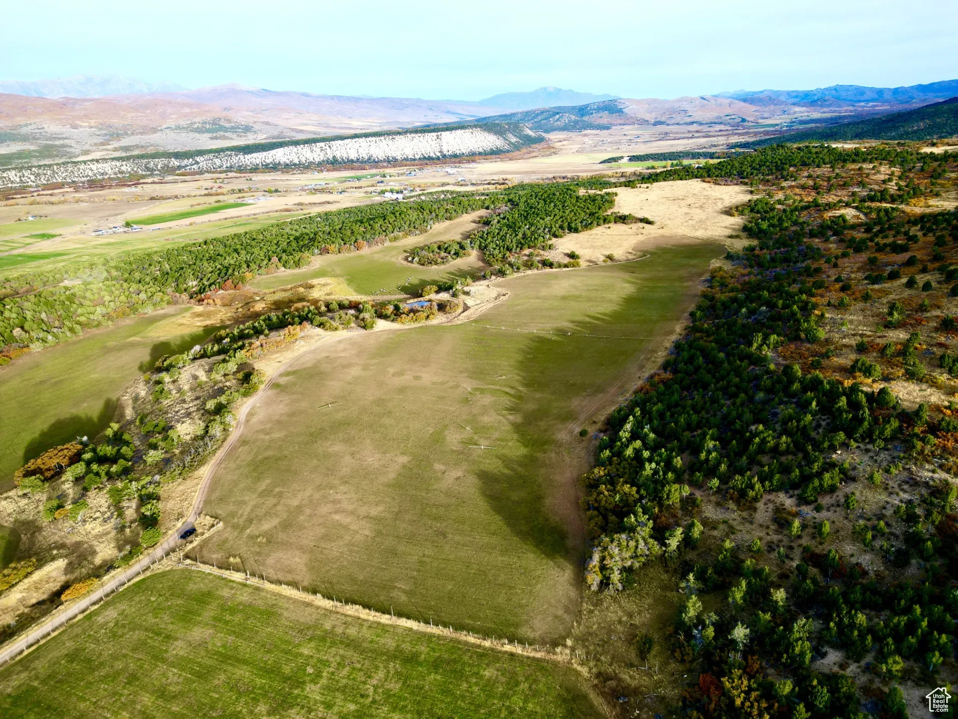 Drone / aerial view of mountains and a local golf course