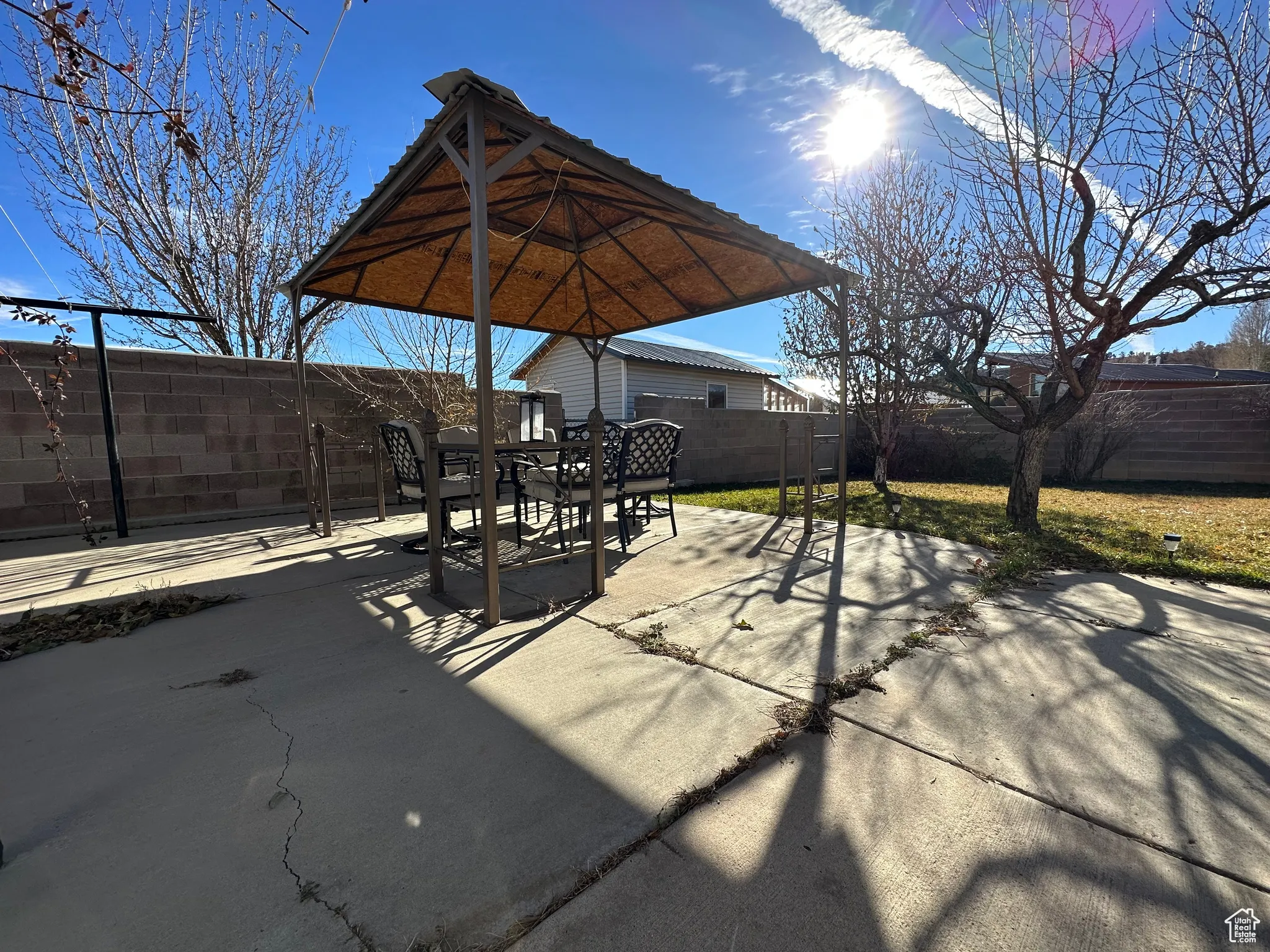 Fenced backyard with a patio area and outdoor dining space