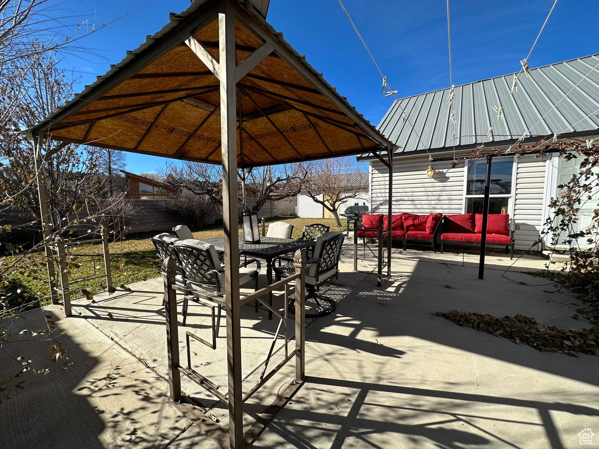 View of patio featuring outdoor dining area and a gazebo
