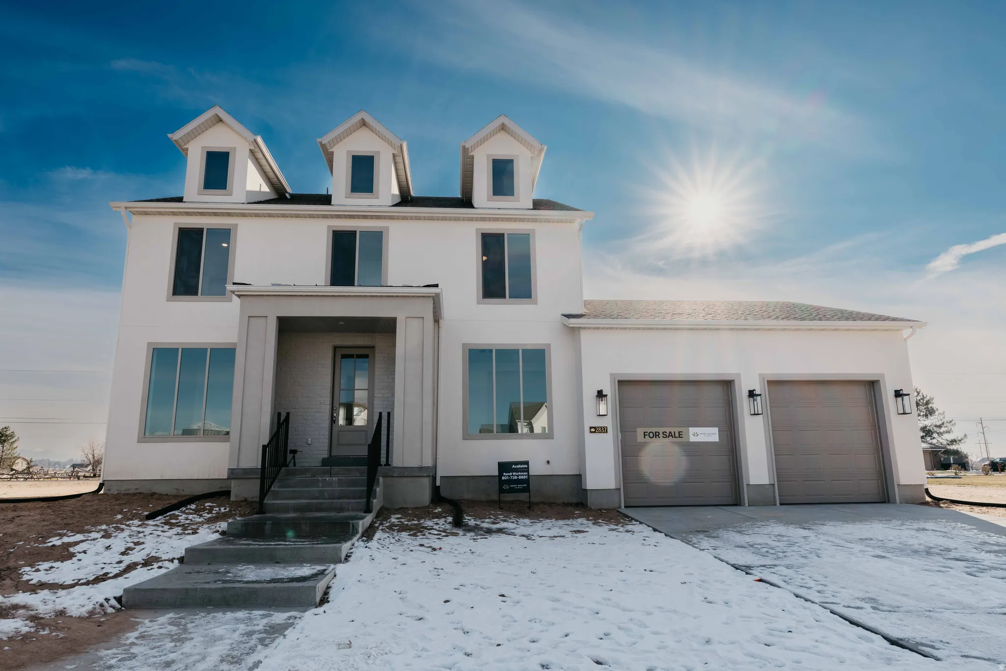 View of front of house featuring an attached garage and stucco siding