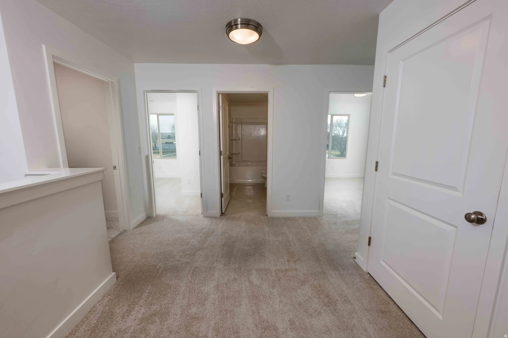 Hall with light carpet and baseboards