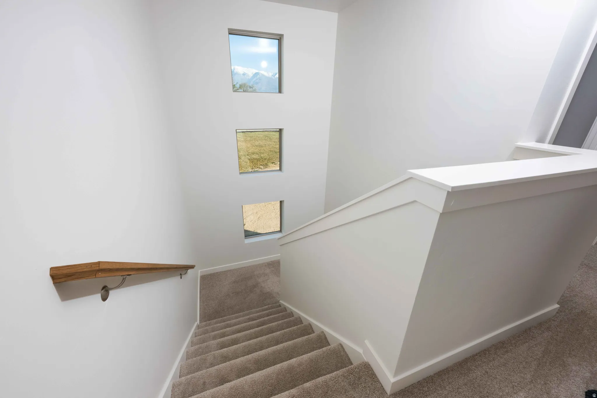 Stairway featuring carpet and baseboards