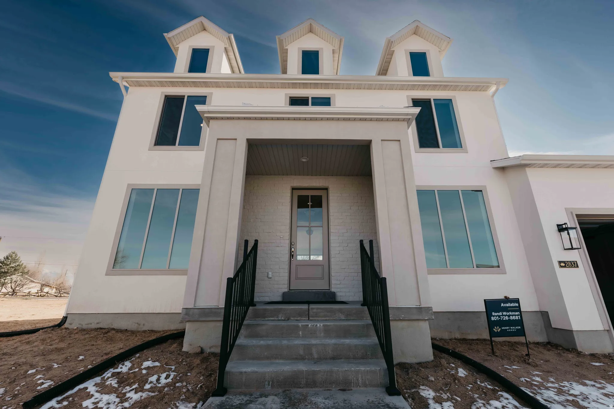 View of front of home featuring brick siding and stucco siding