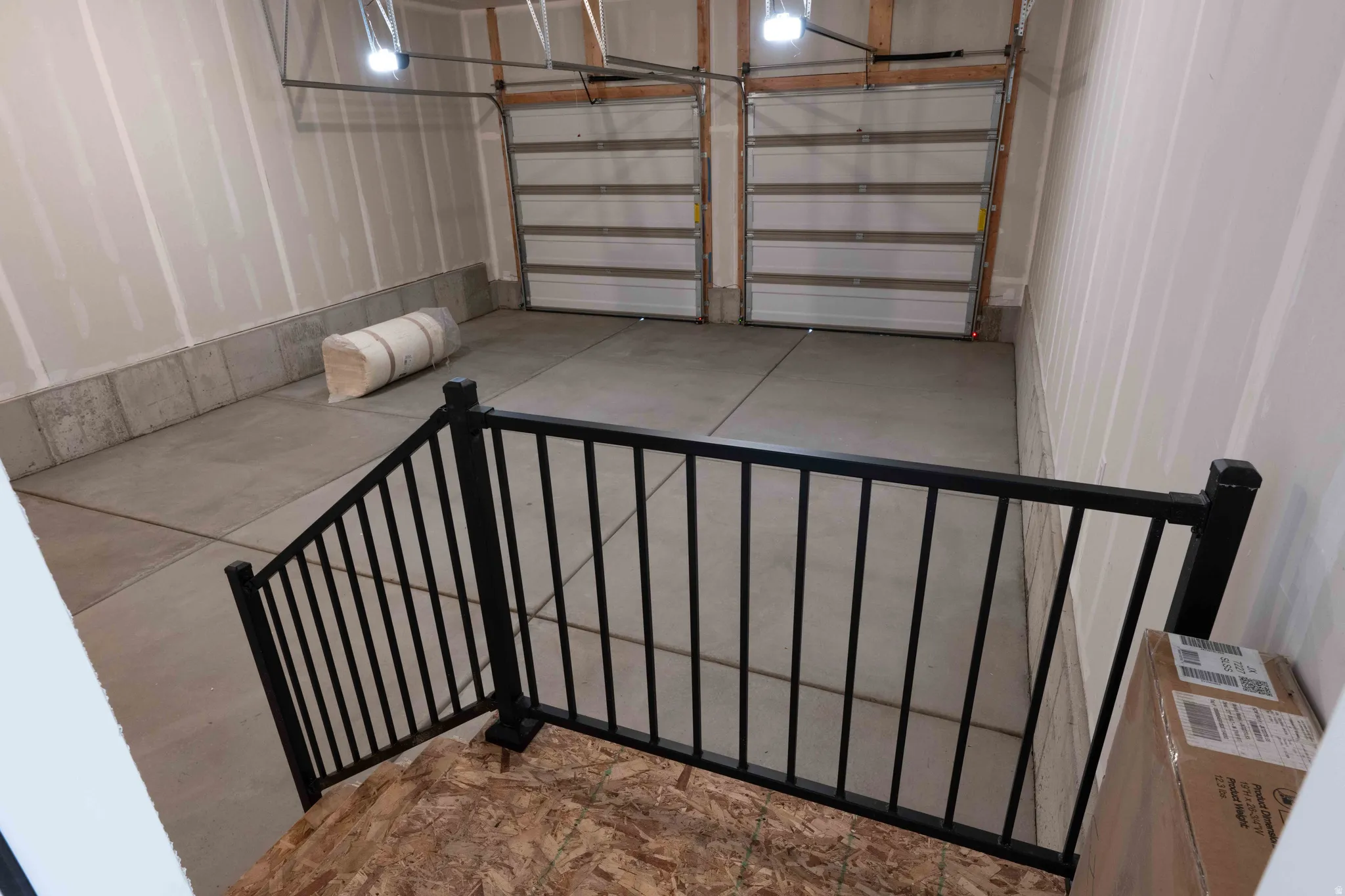 Garage - stairs with railing & concrete floors