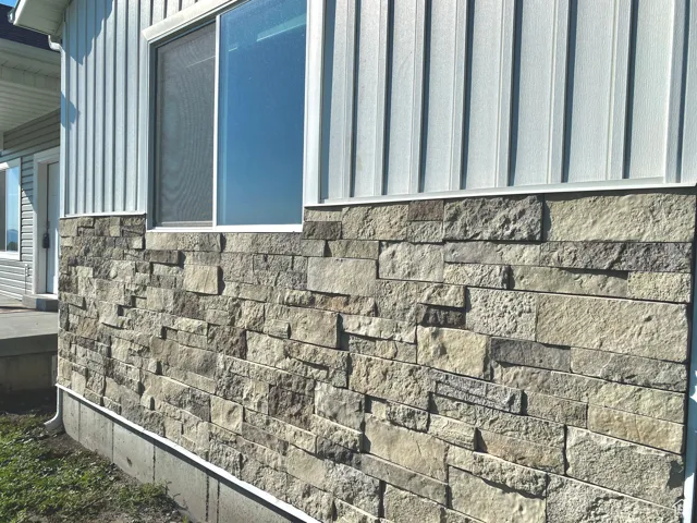 Exterior view of board and batten siding and stone siding