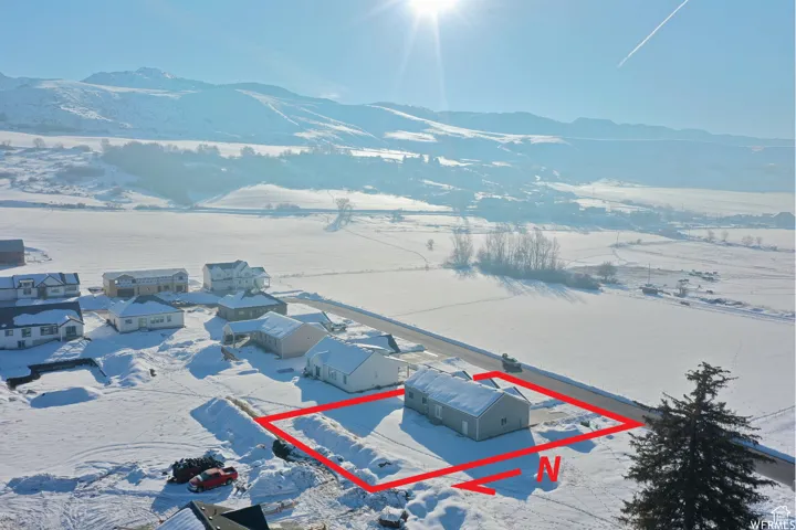 Snowy aerial view featuring a mountain view