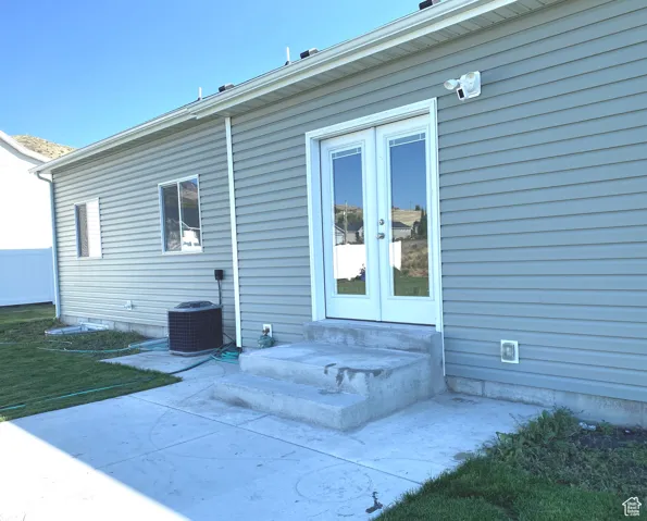 Rear view of house featuring the patio with entry steps into semi-formal dining in the kitchen, french doors.