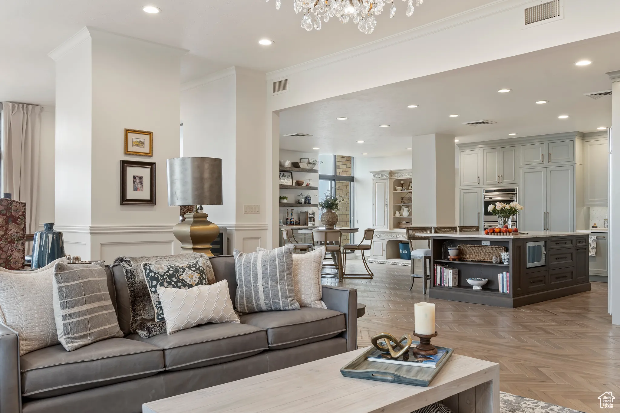 Living area with crown molding and recessed lighting