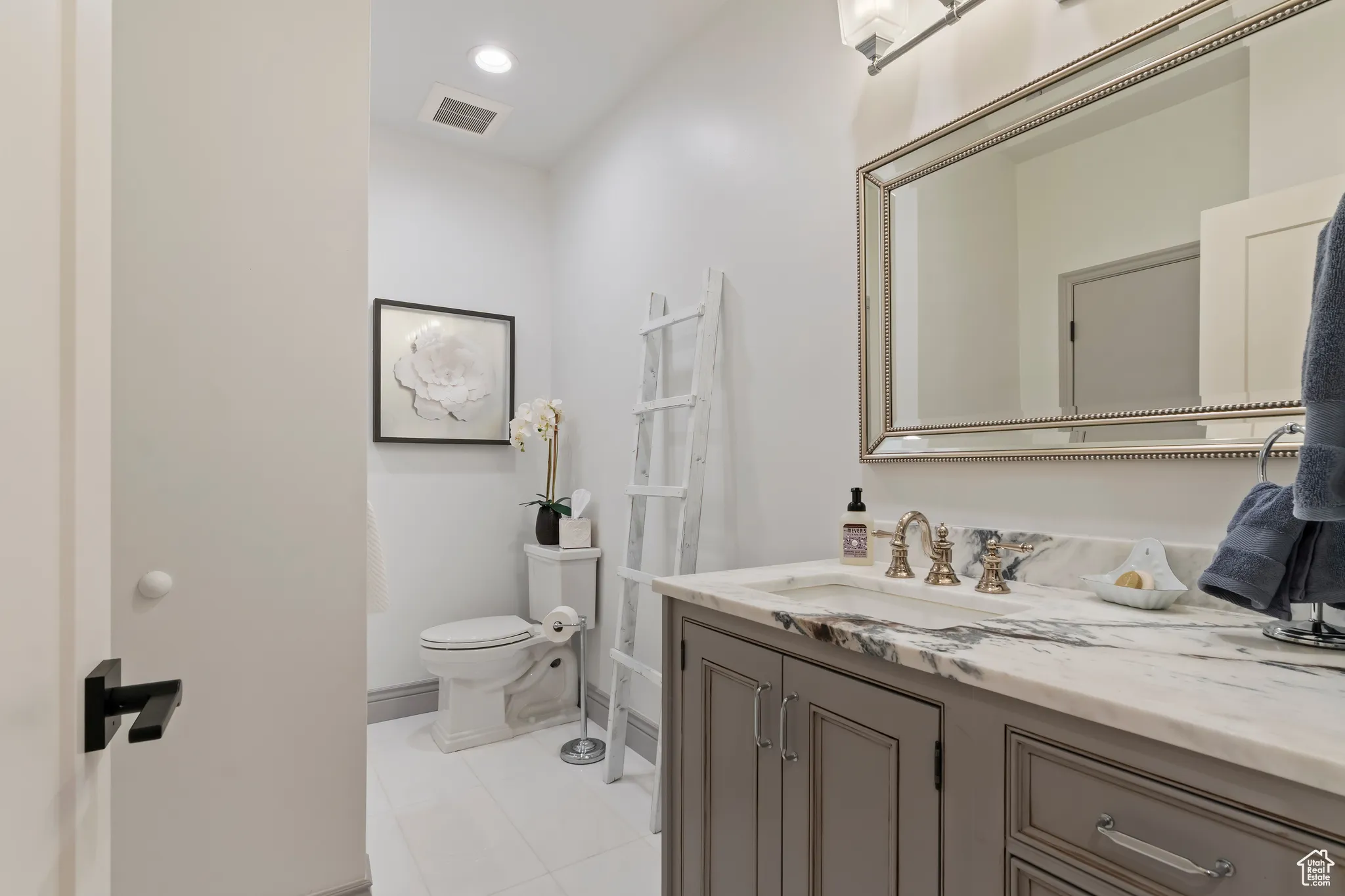 Bathroom featuring vanity, tile patterned flooring, and recessed lighting