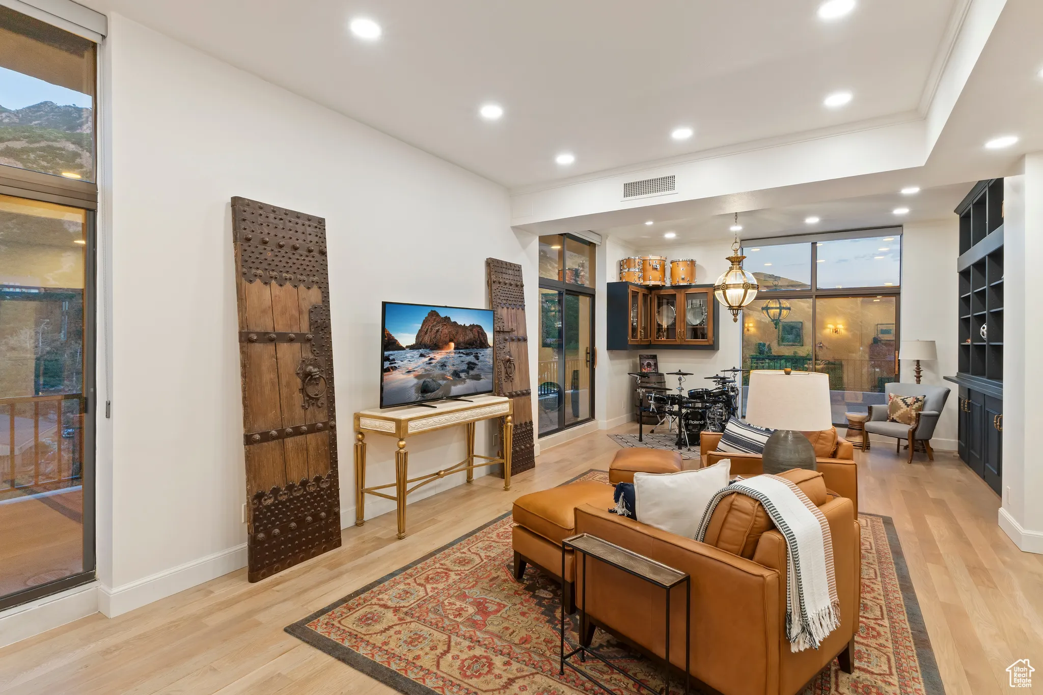 Living area with recessed lighting, light wood-style flooring, and a fireplace