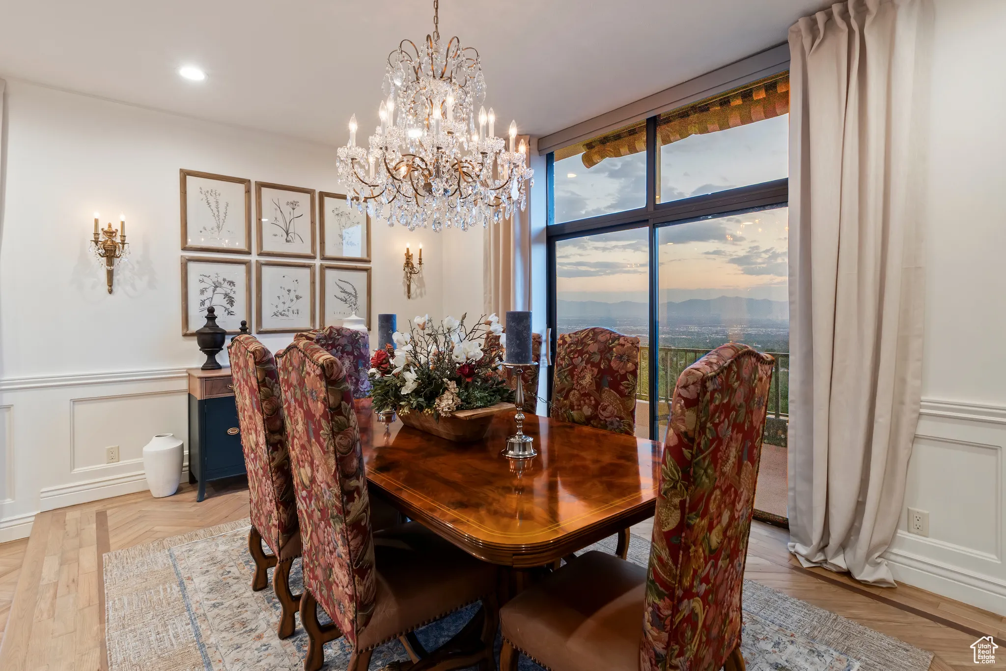 Dining room featuring a decorative wall, wainscoting, and a chandelier