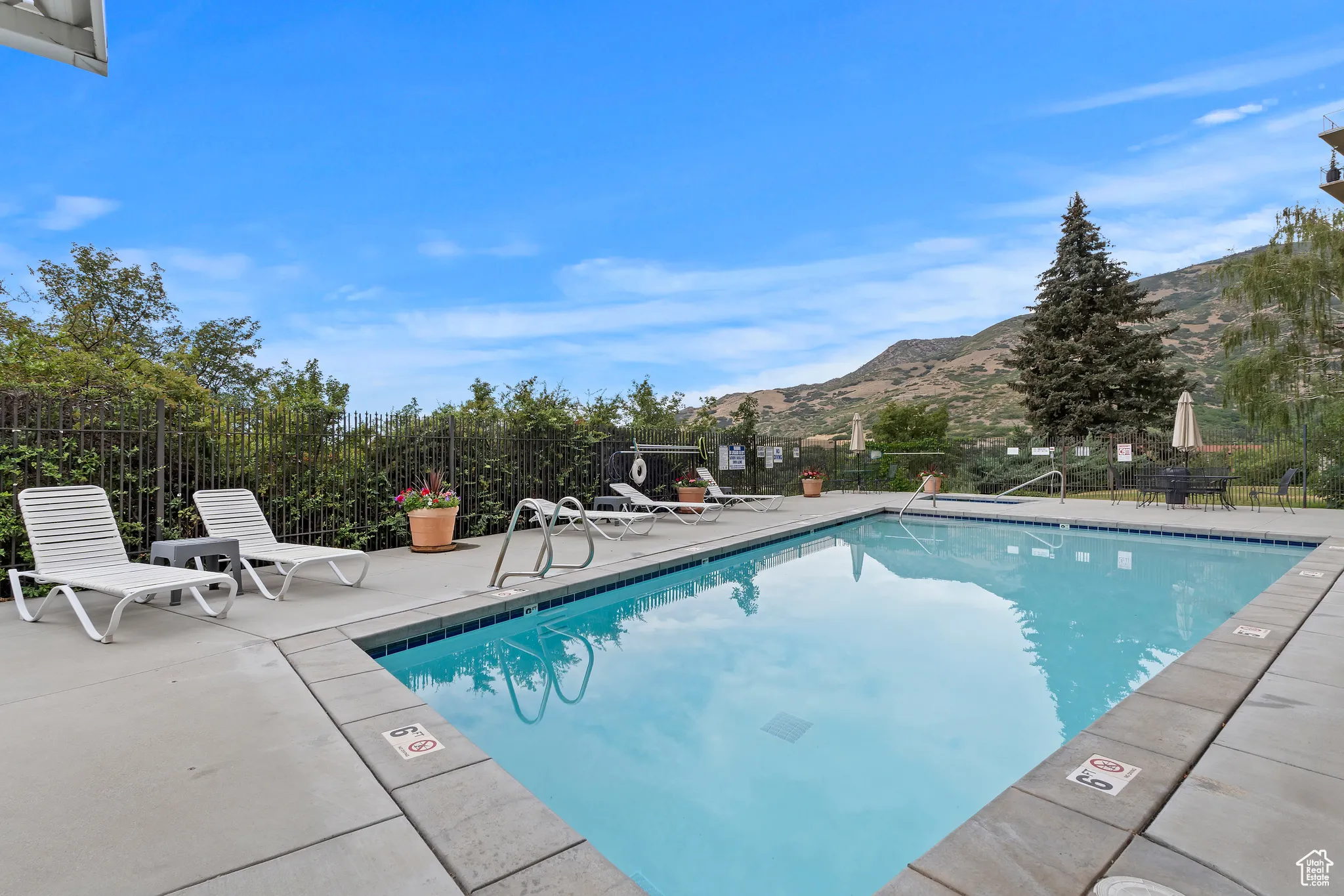 Community pool featuring a mountain view and a patio area