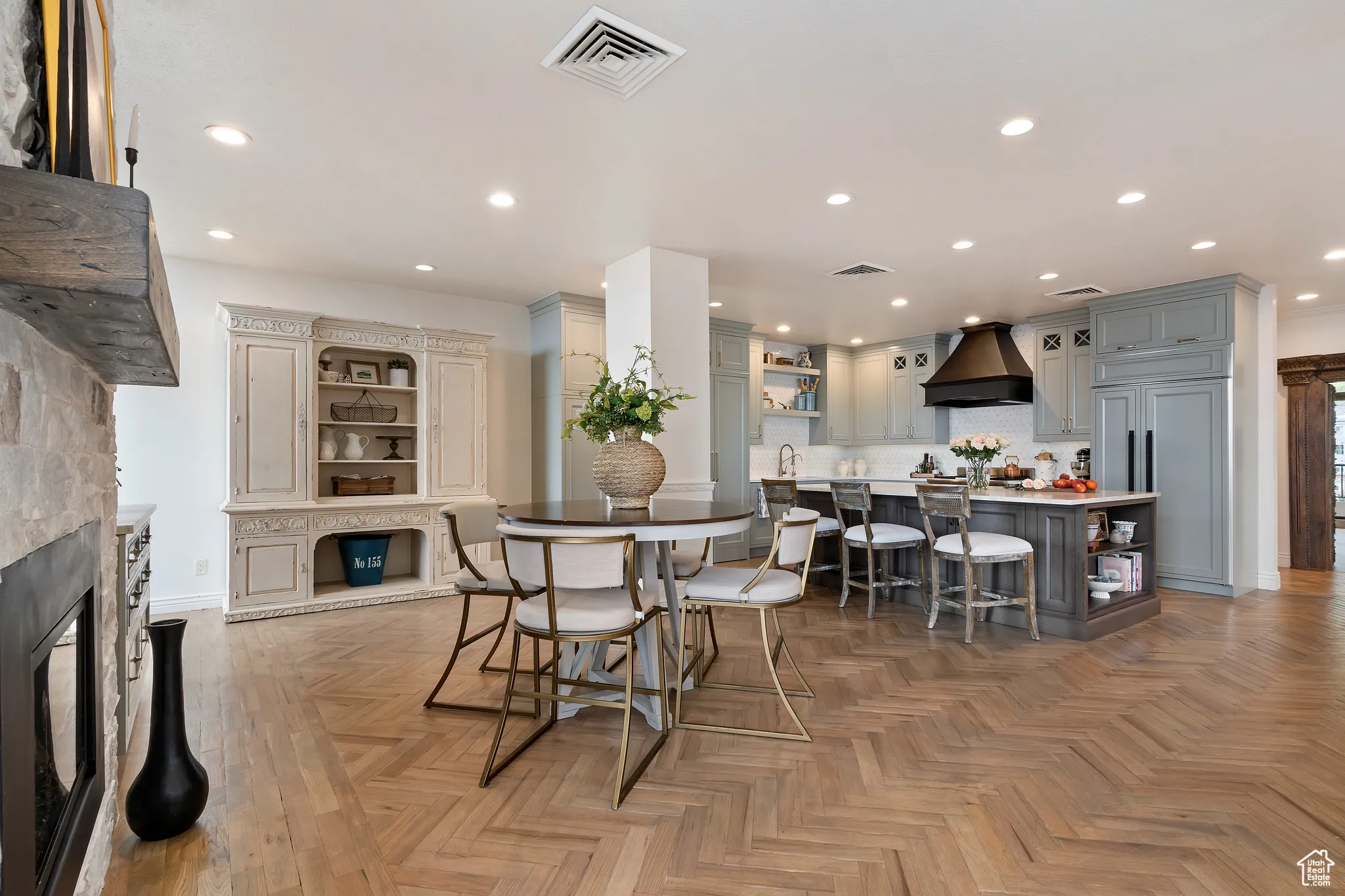 Dining area with a stone fireplace and recessed lighting
