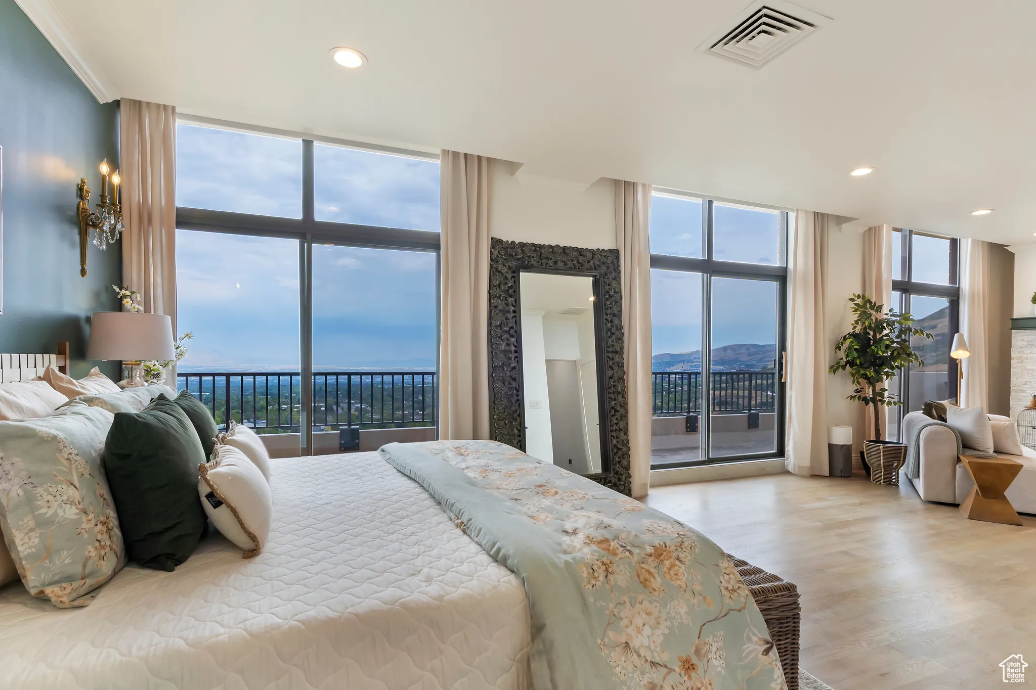 Bedroom with access to exterior, floor to ceiling windows, wood finished floors, and recessed lighting