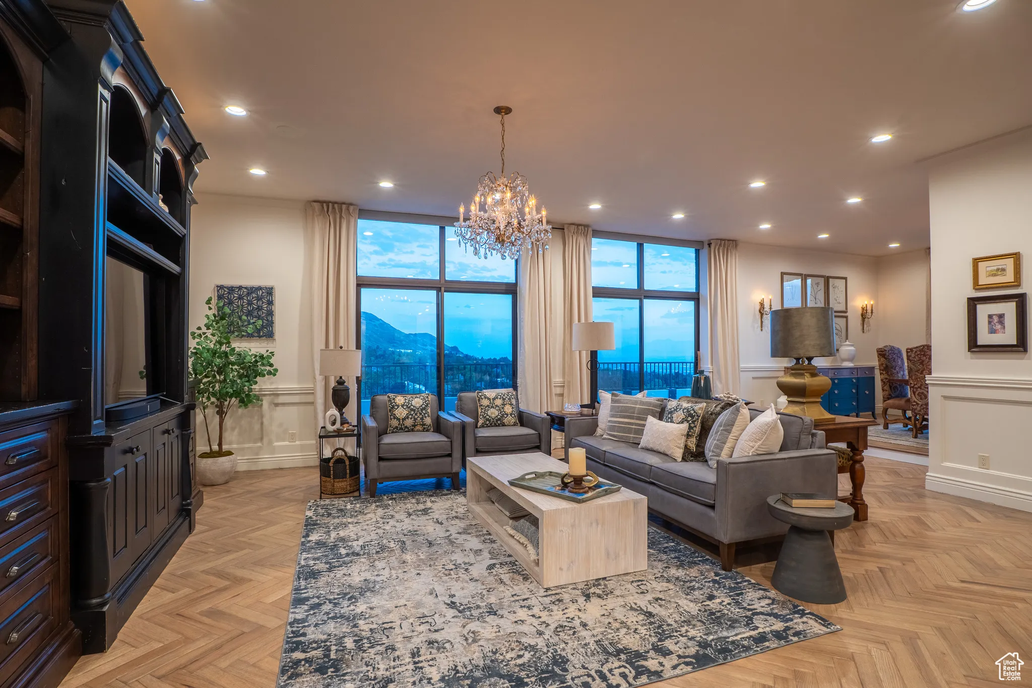 Living area with recessed lighting, a chandelier, a wainscoted wall, a mountain view, and a decorative wall