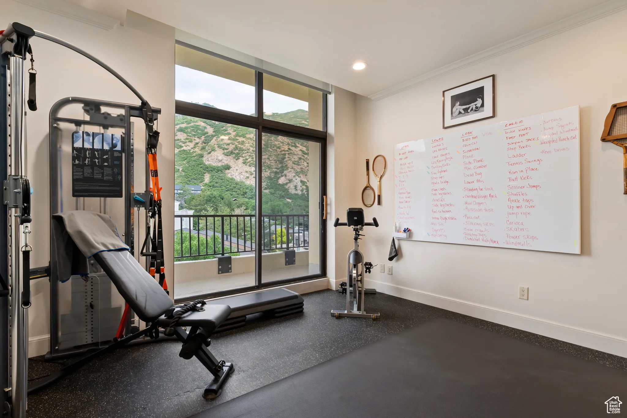 Workout room featuring ornamental molding, recessed lighting, and a wall of windows