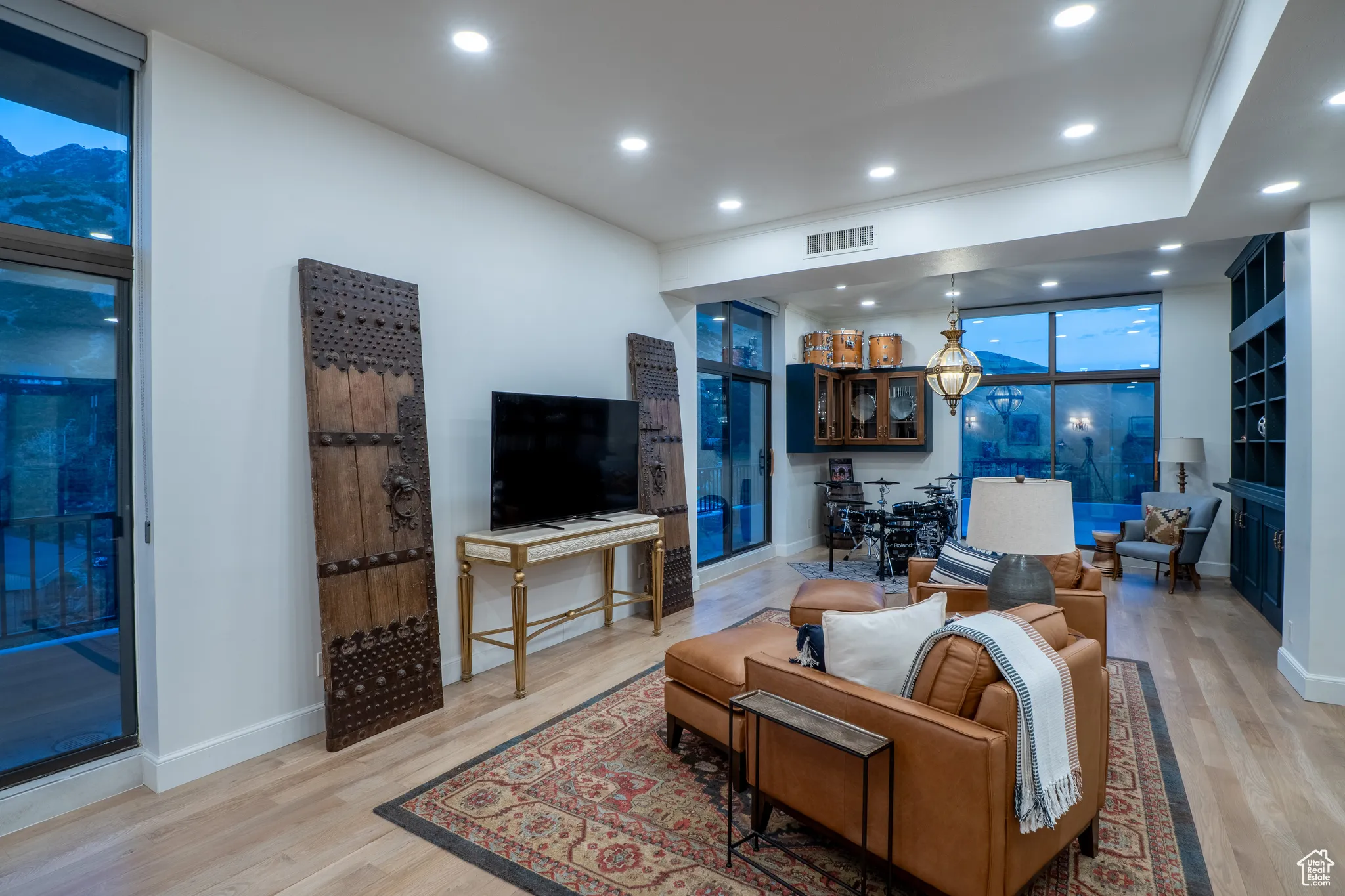 Living room featuring recessed lighting, wood finished floors, and a wall of windows