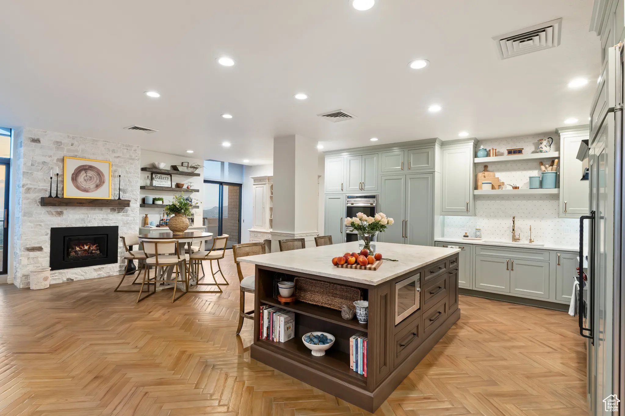 Kitchen with open shelves, decorative backsplash, recessed lighting, a fireplace, and a center island