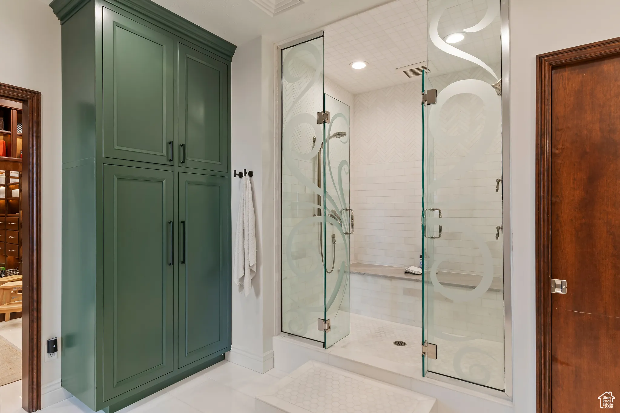 Full bath with a stall shower, tile patterned floors, and a closet