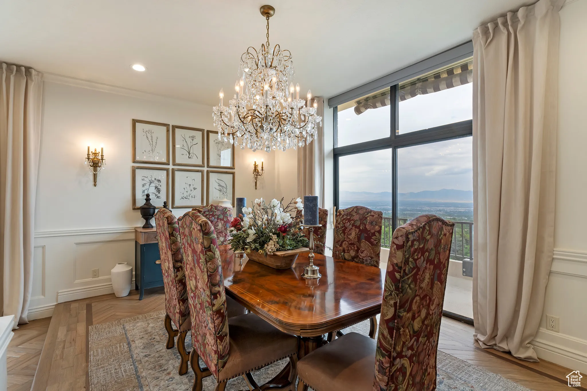 Dining room with wainscoting, a chandelier, recessed lighting, a decorative wall, and a mountain view