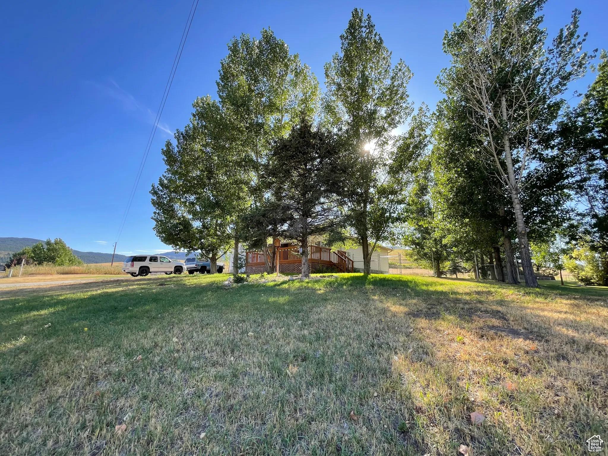 View of green lawn featuring a mountain view