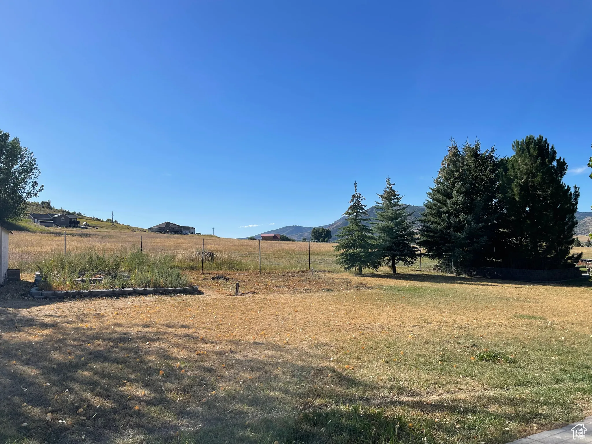 View of grassy yard with a mountain view and a view of countryside