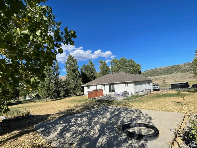 View of front of property with a patio and an outdoor fire pit