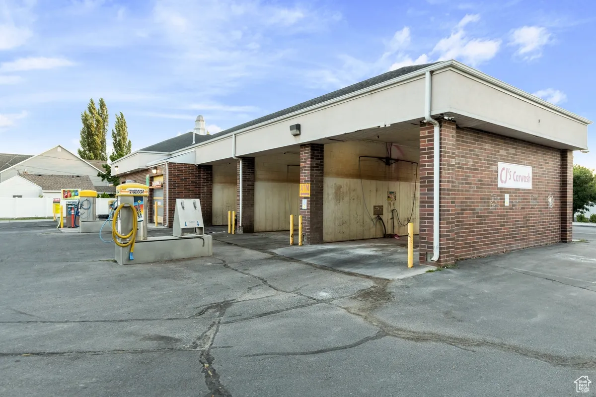 View of side of home featuring brick siding and covered parking