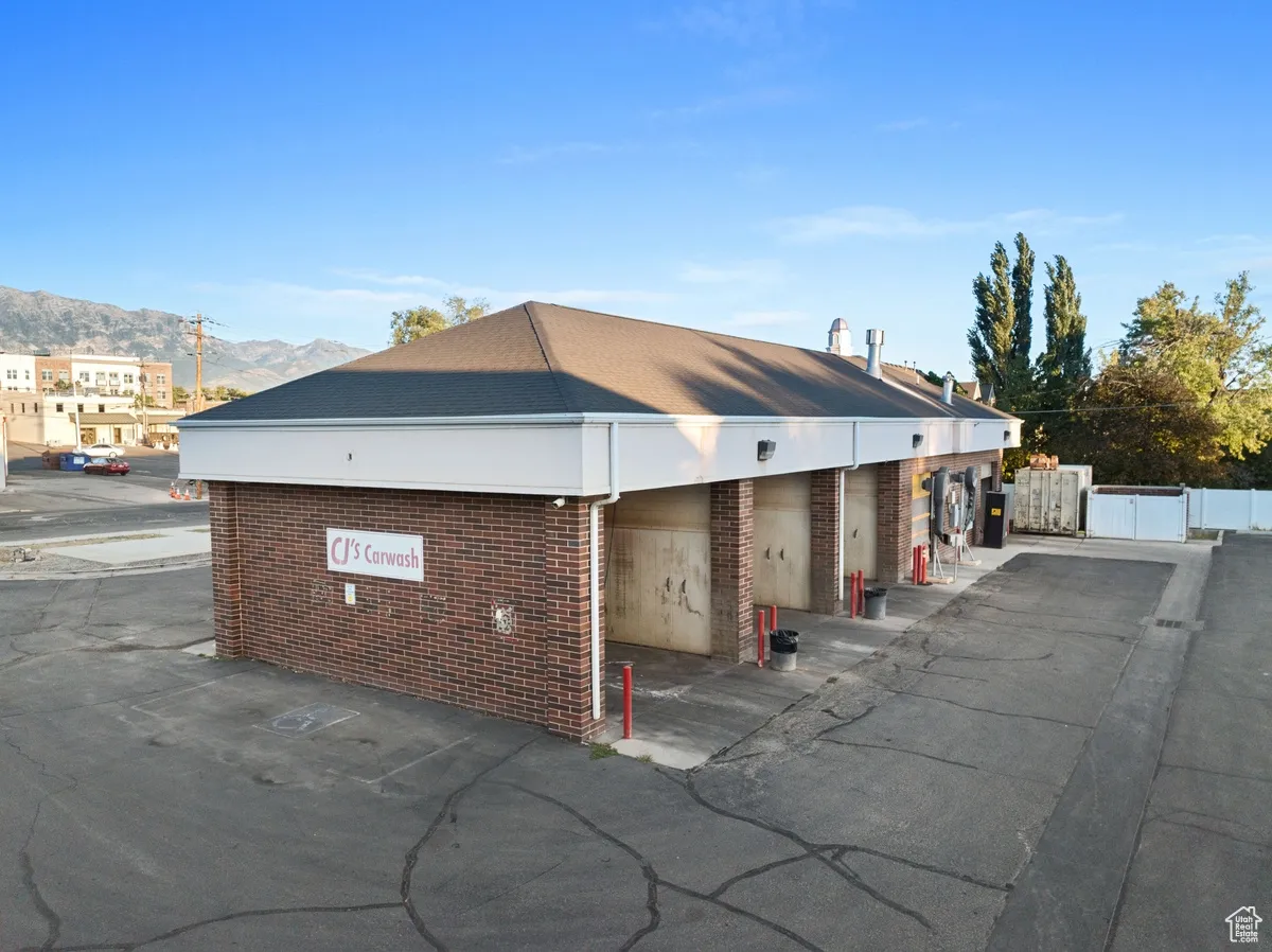 View of property exterior featuring brick siding and a mountain view
