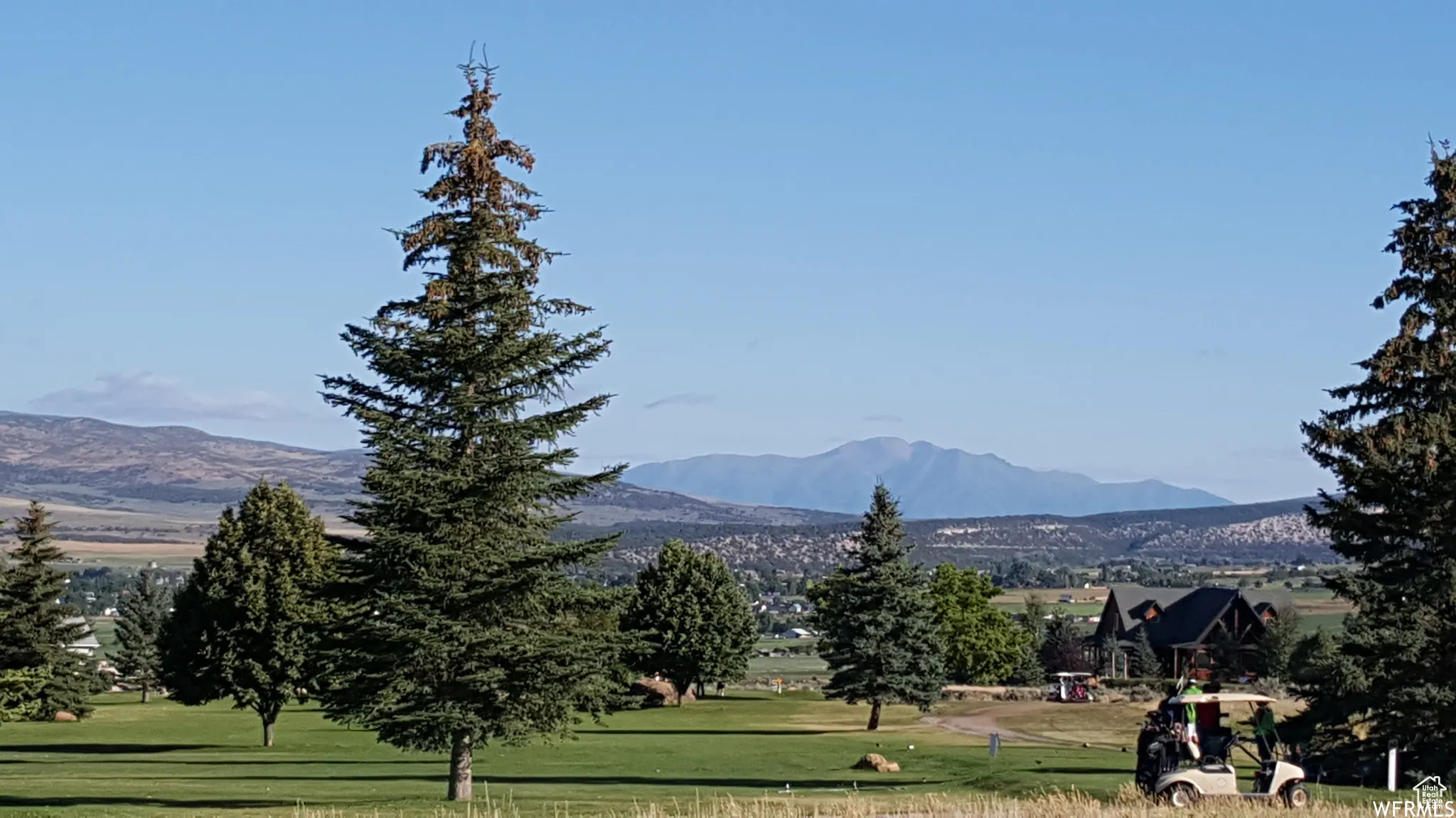 Surrounding community featuring a lawn and a mountain view