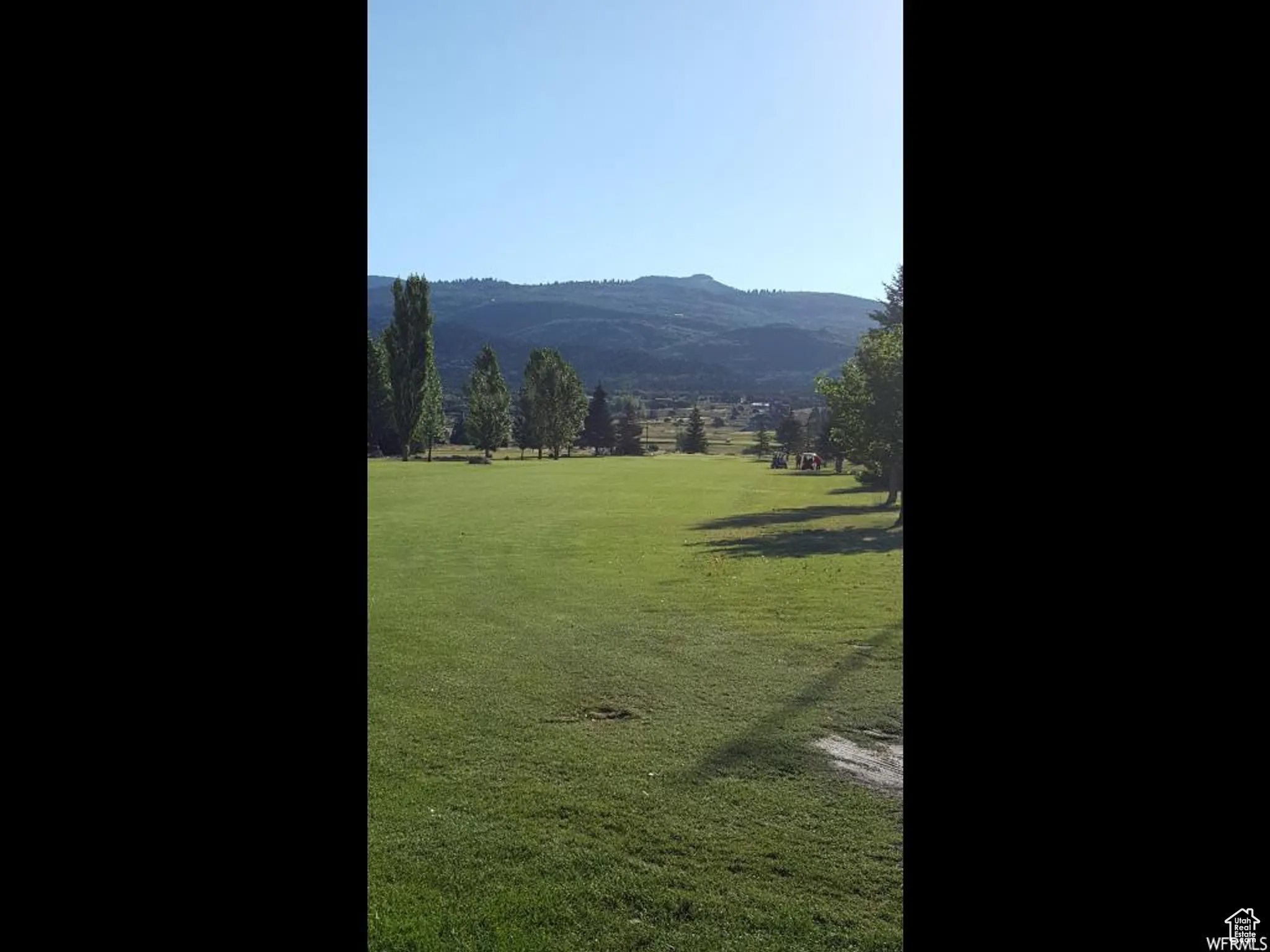 Surrounding community with a mountain view, a yard, and a view of rural / pastoral area