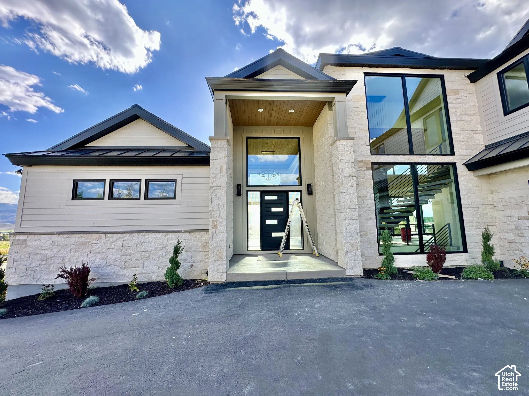 Modern exterior featuring stacked stone and horizontal siding