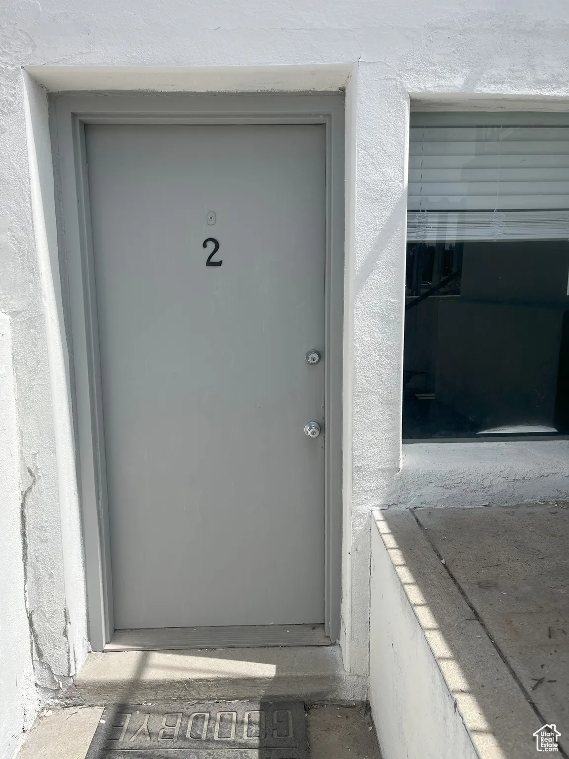 Doorway to property featuring stucco siding