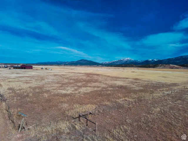 View of yard with a mountain view and a view of rural / pastoral area