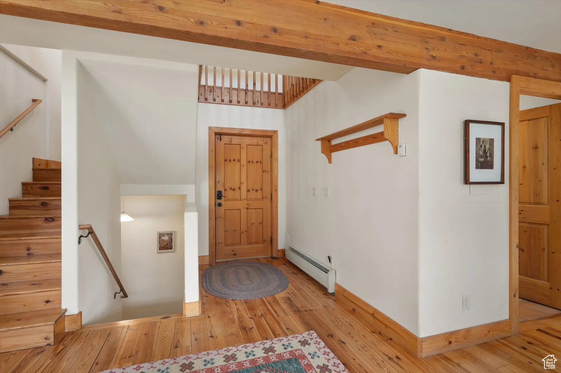 Entryway featuring knotty pine floors and exposed beams