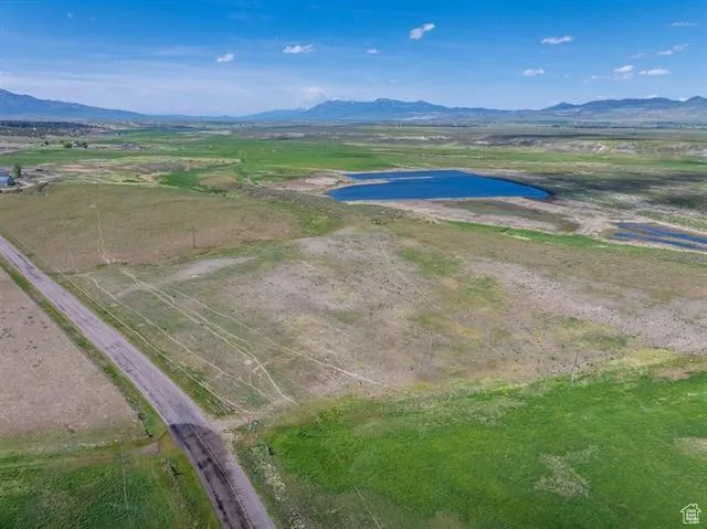 Aerial view of sparsely populated area with a water and mountain view