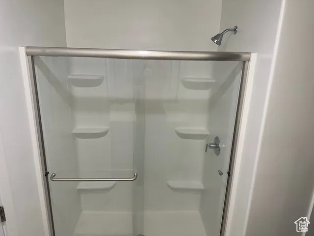 Full bathroom with a shower stall