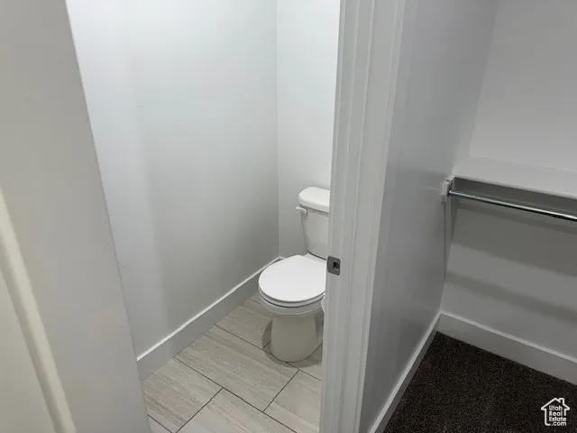 Bathroom with baseboards and toilet