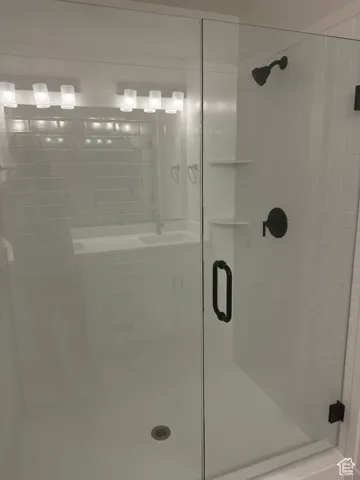 Bathroom with a stall shower and a sink