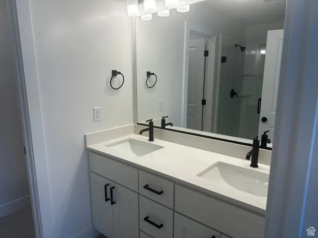 Bathroom with a sink and a shower stall