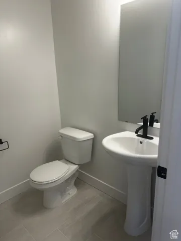 Bathroom featuring baseboards and light tile patterned floors