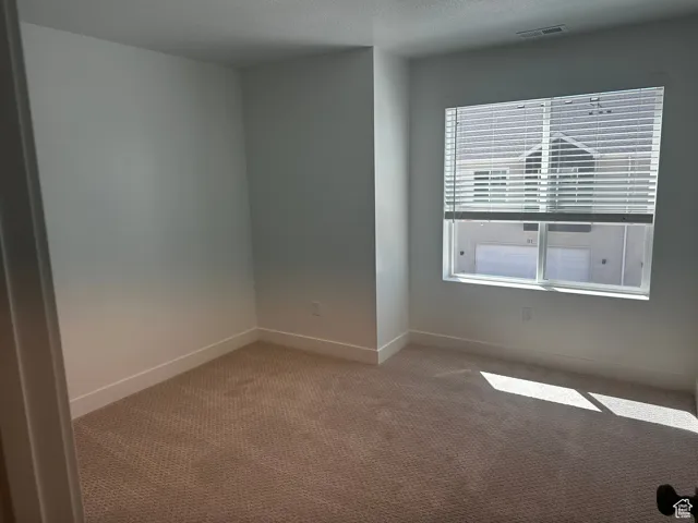 Spare room with carpet and a textured ceiling
